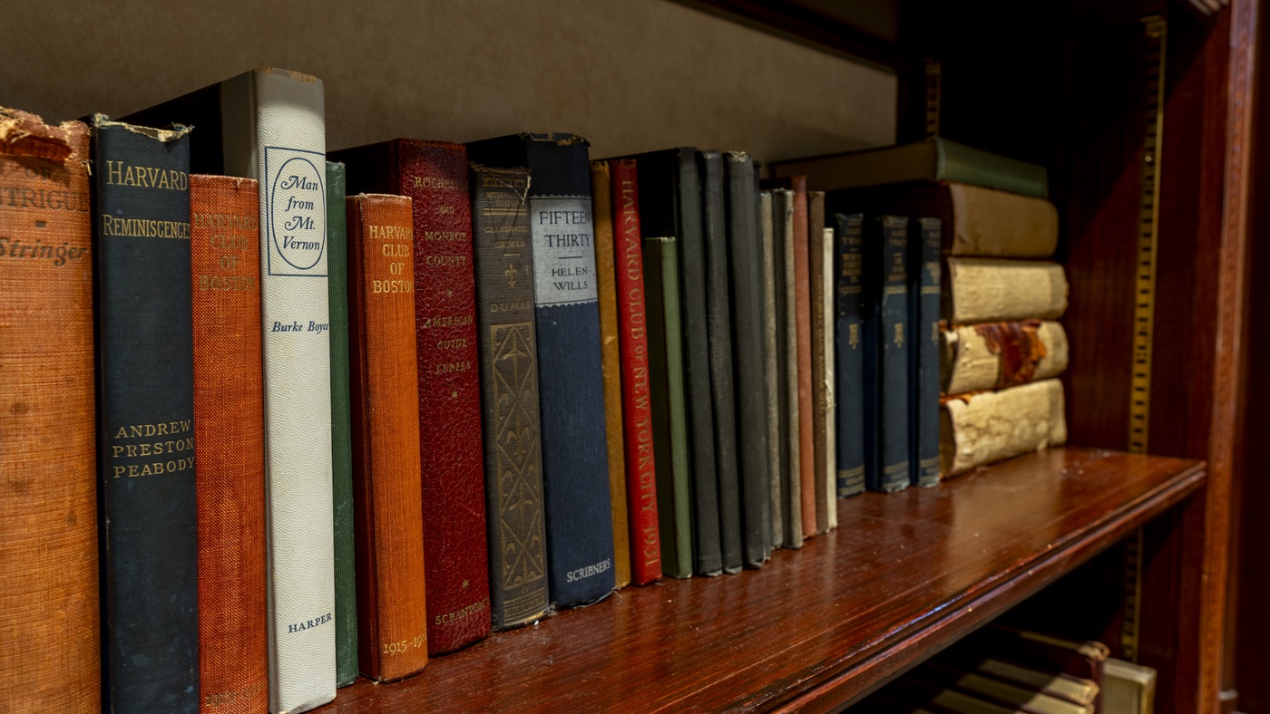 Vintage books on a dark wooden shellf