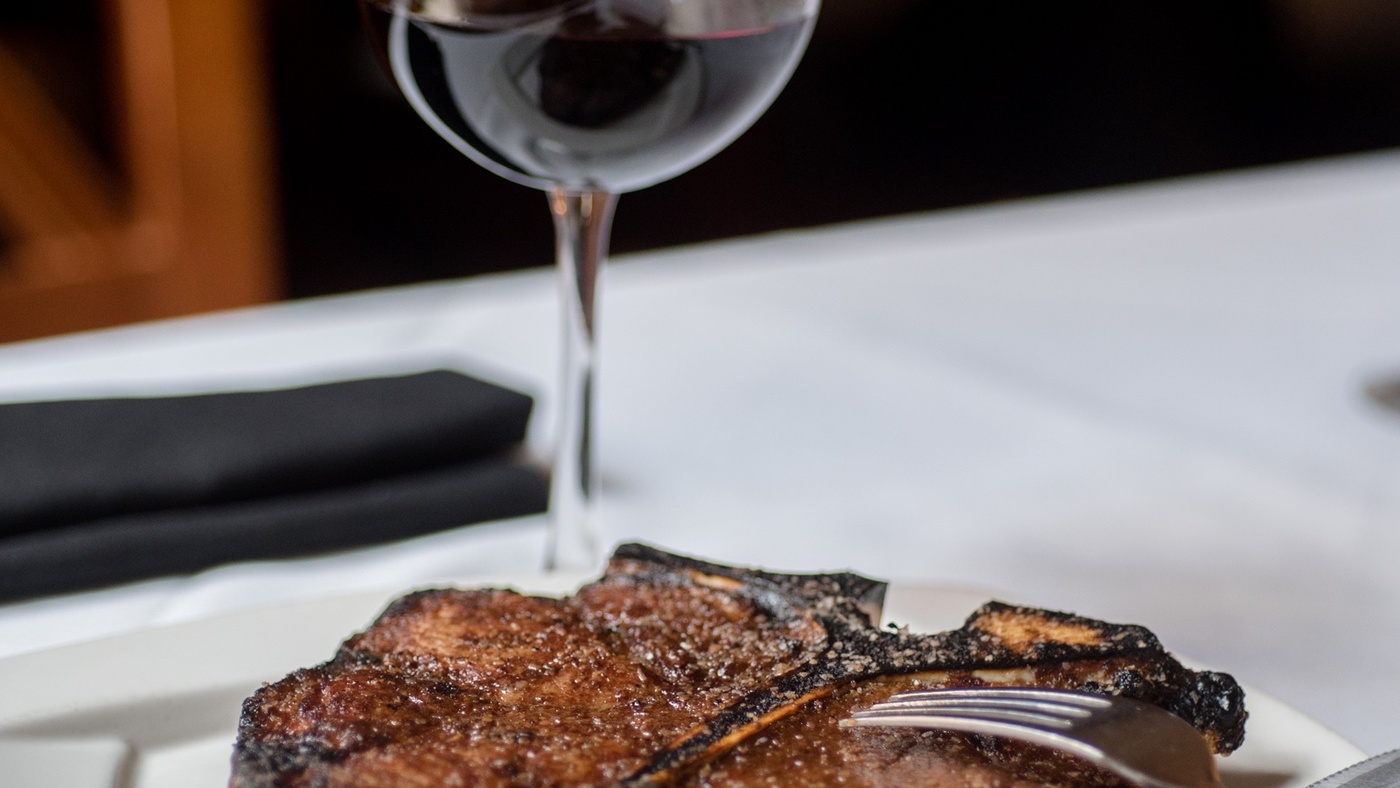 Porterhouse steak with glass of red wine
