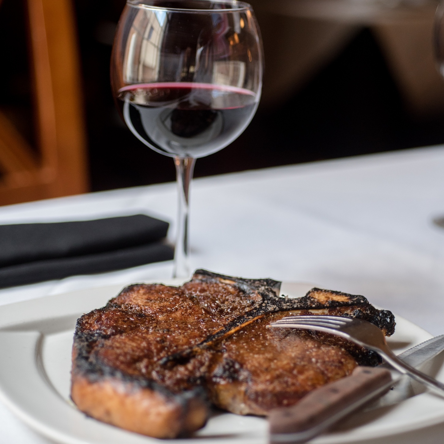 Porterhouse steak with glass of red wine